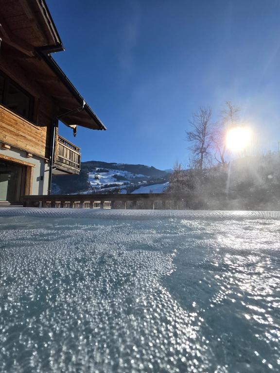 Private whirlpool with a view of the snow-covered mountains